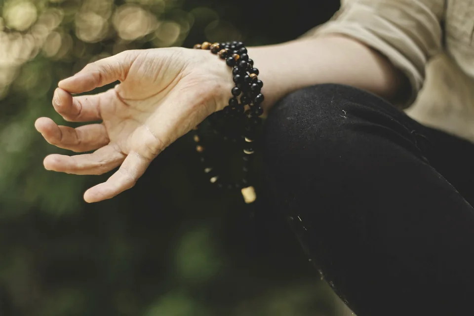 A hand resting in a calm meditation mudra.