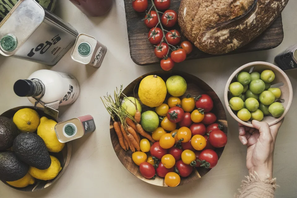 Fresh fruit, vegetables and whole foods arranged on a table.